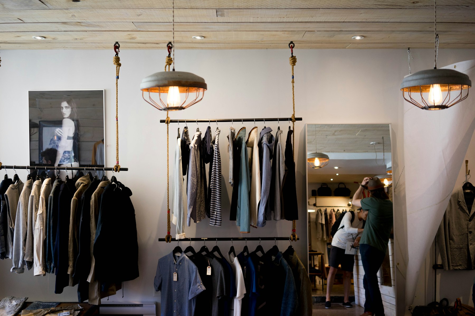 The boutique's interior, clothing racks lit by natural light