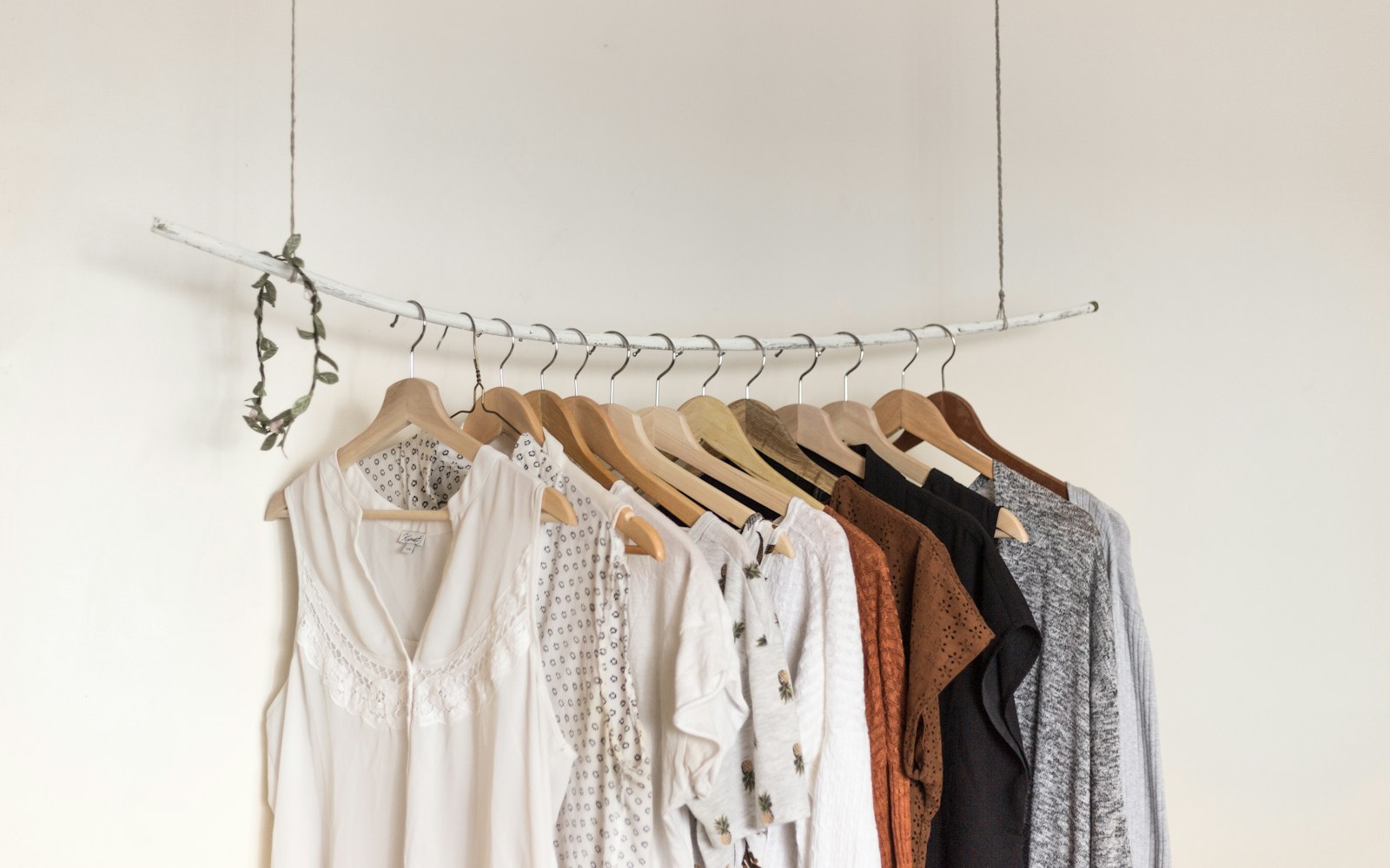 Linen and cotton pieces laid out on a table in a boutique, in sand, white and oatmeal