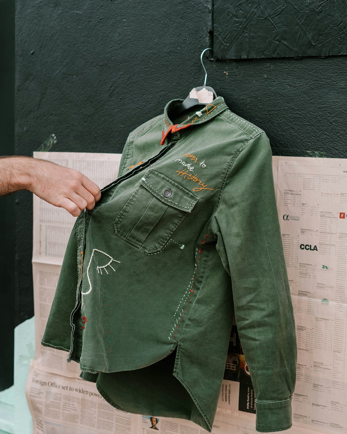 Indigo cotton twill chore jacket with three patch pockets and a button front