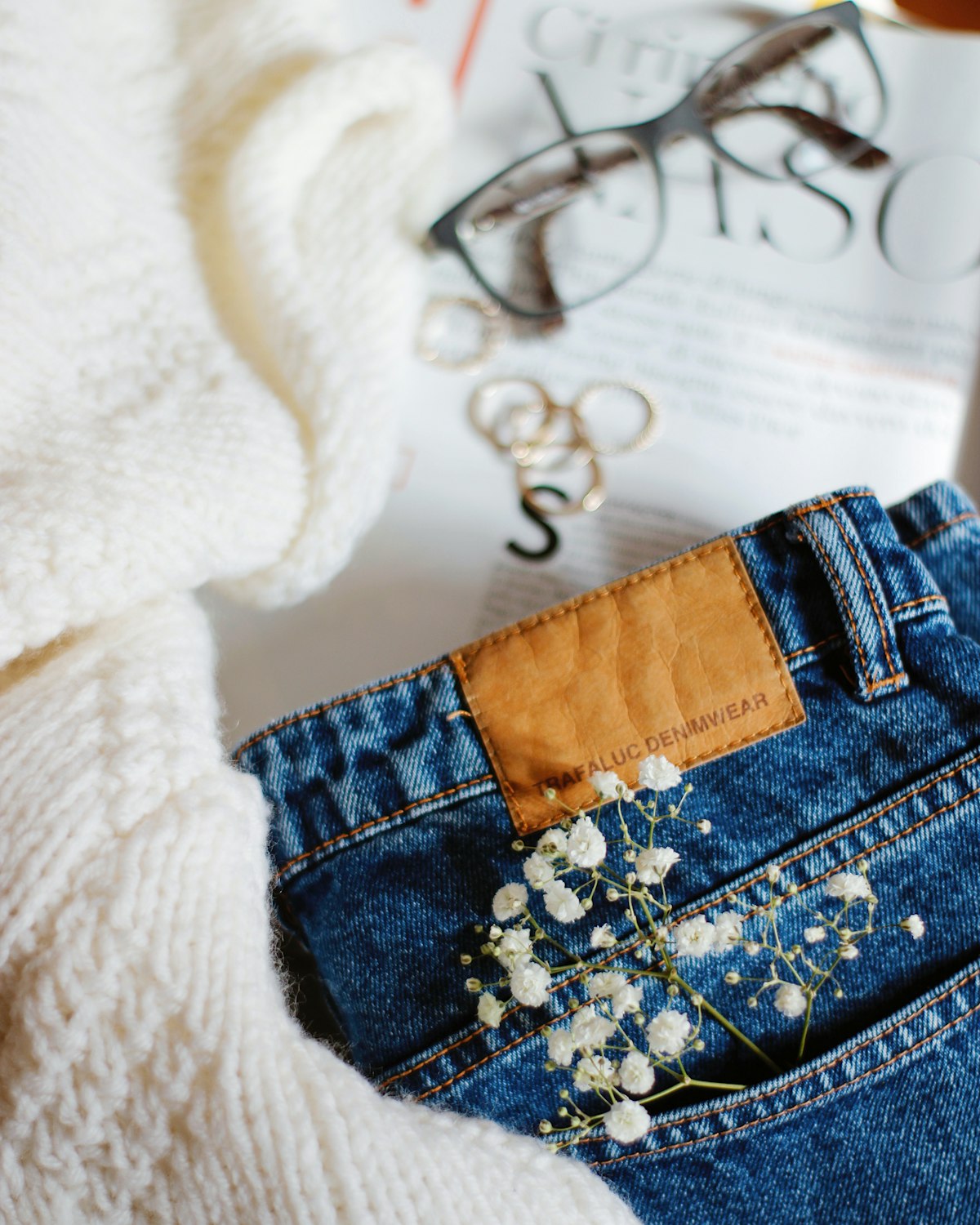 Ecru denim skirt with patch pockets, a button front and an above the knee hem