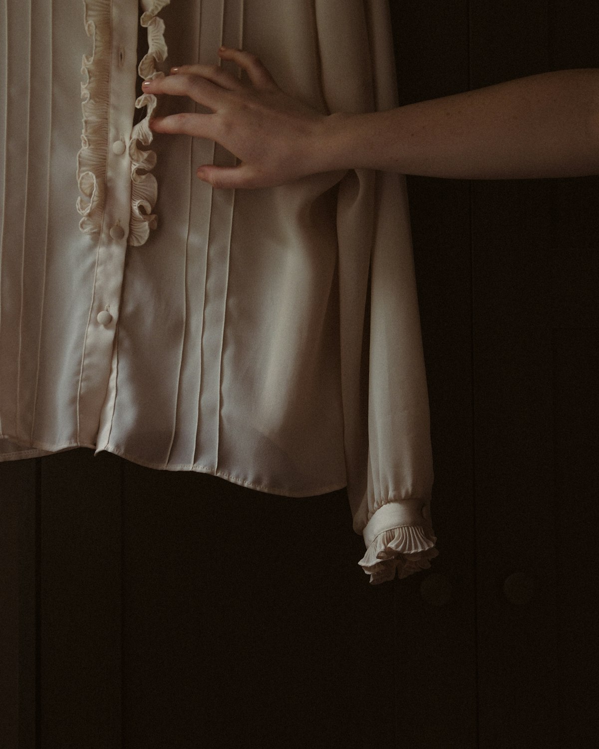 Blush silk blend blouse with a V neck and softly gathered sleeves