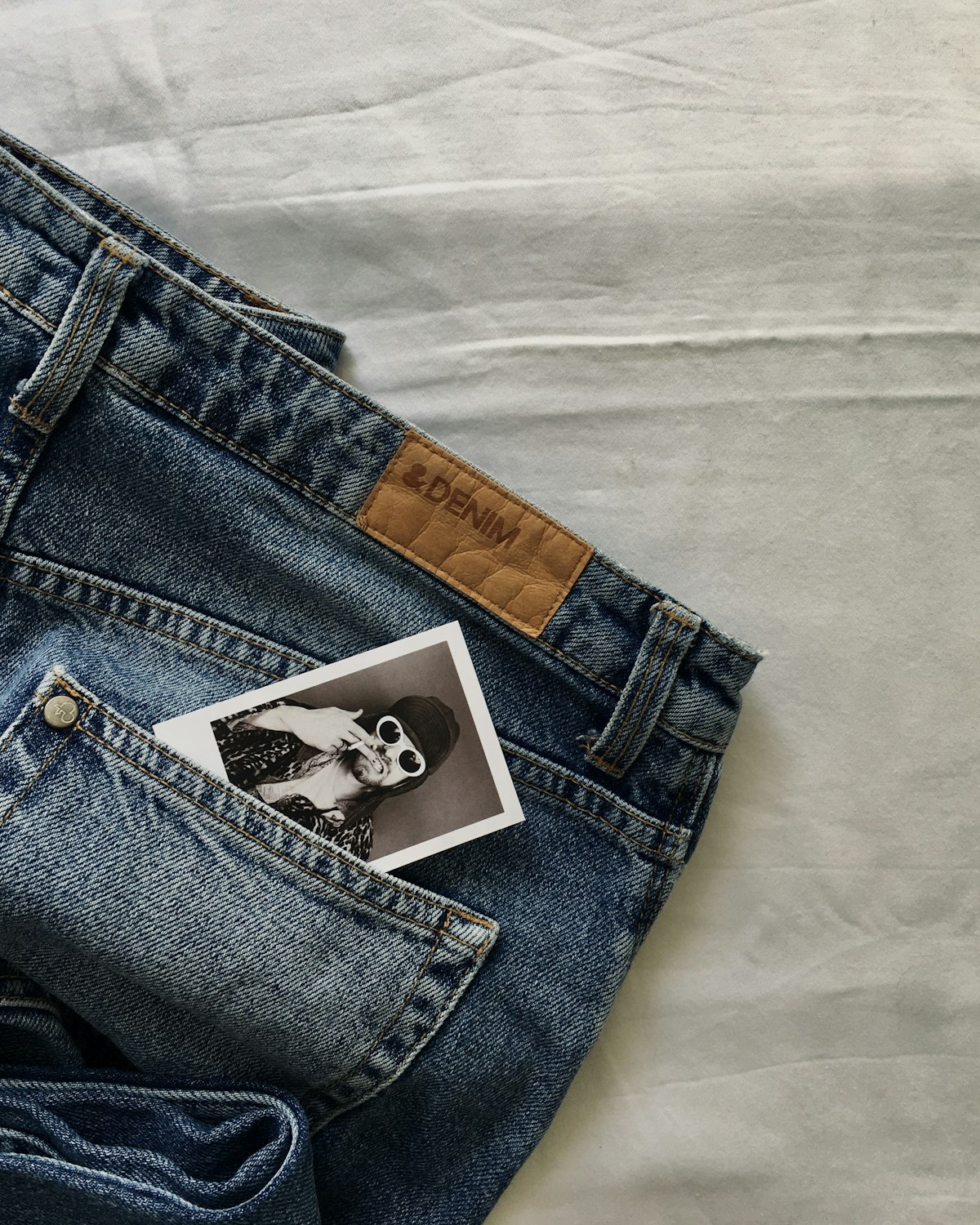 Mid blue wide leg jean with a high rise waist and a full length hem